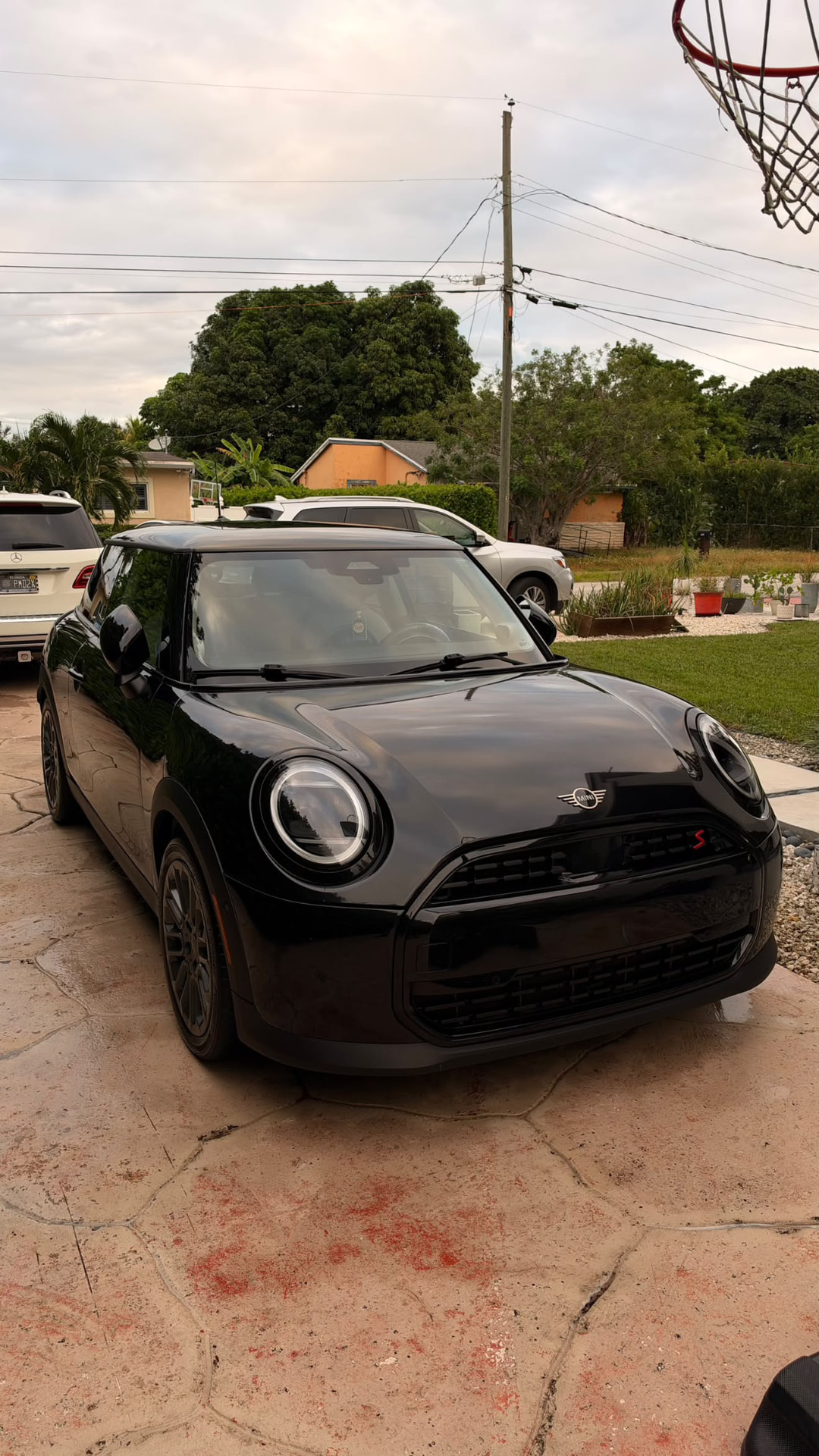 Black Mini Cooper S clean on a residential driveway
