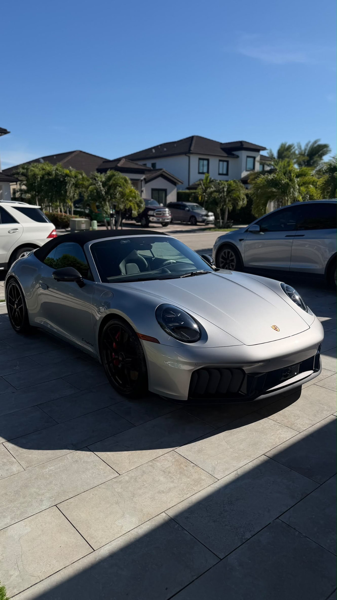 Silver Porsche 911 Cabriolet clean on a stone driveway