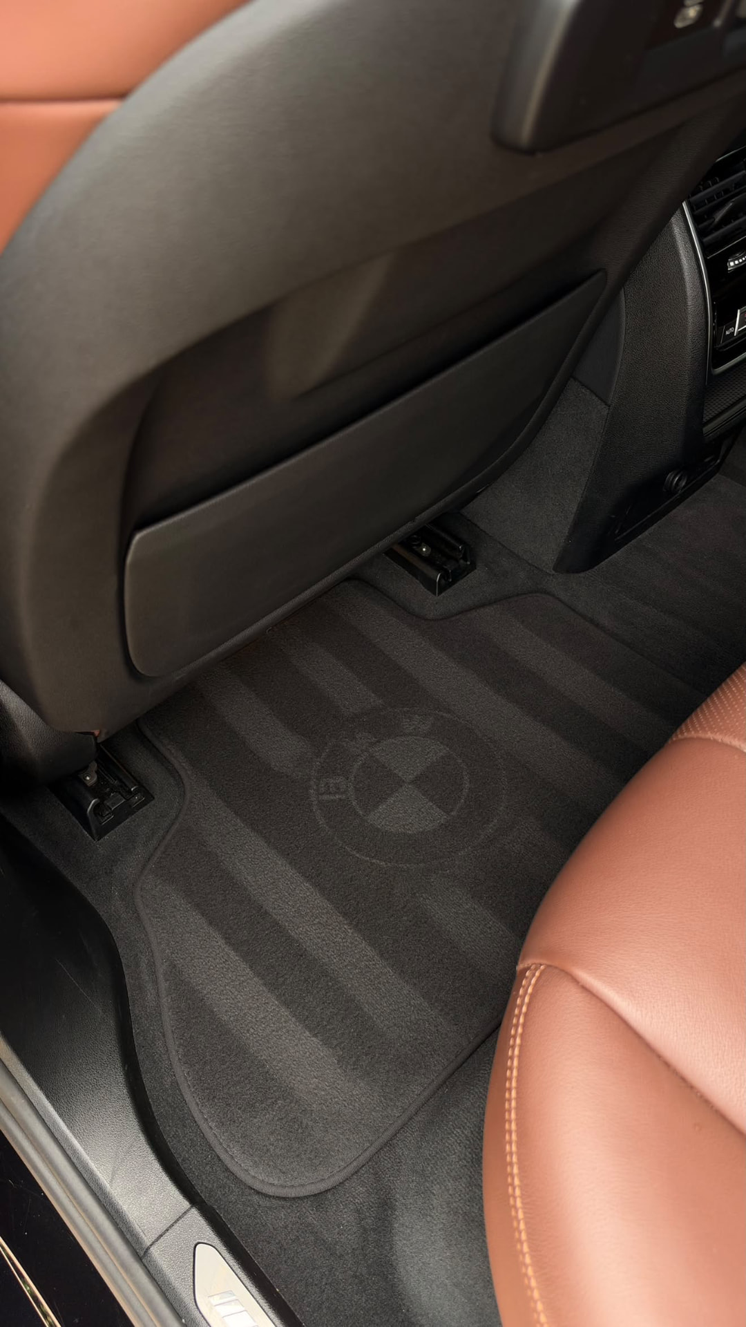 BMW X5 rear footwell with clean carpet and BMW floor mat