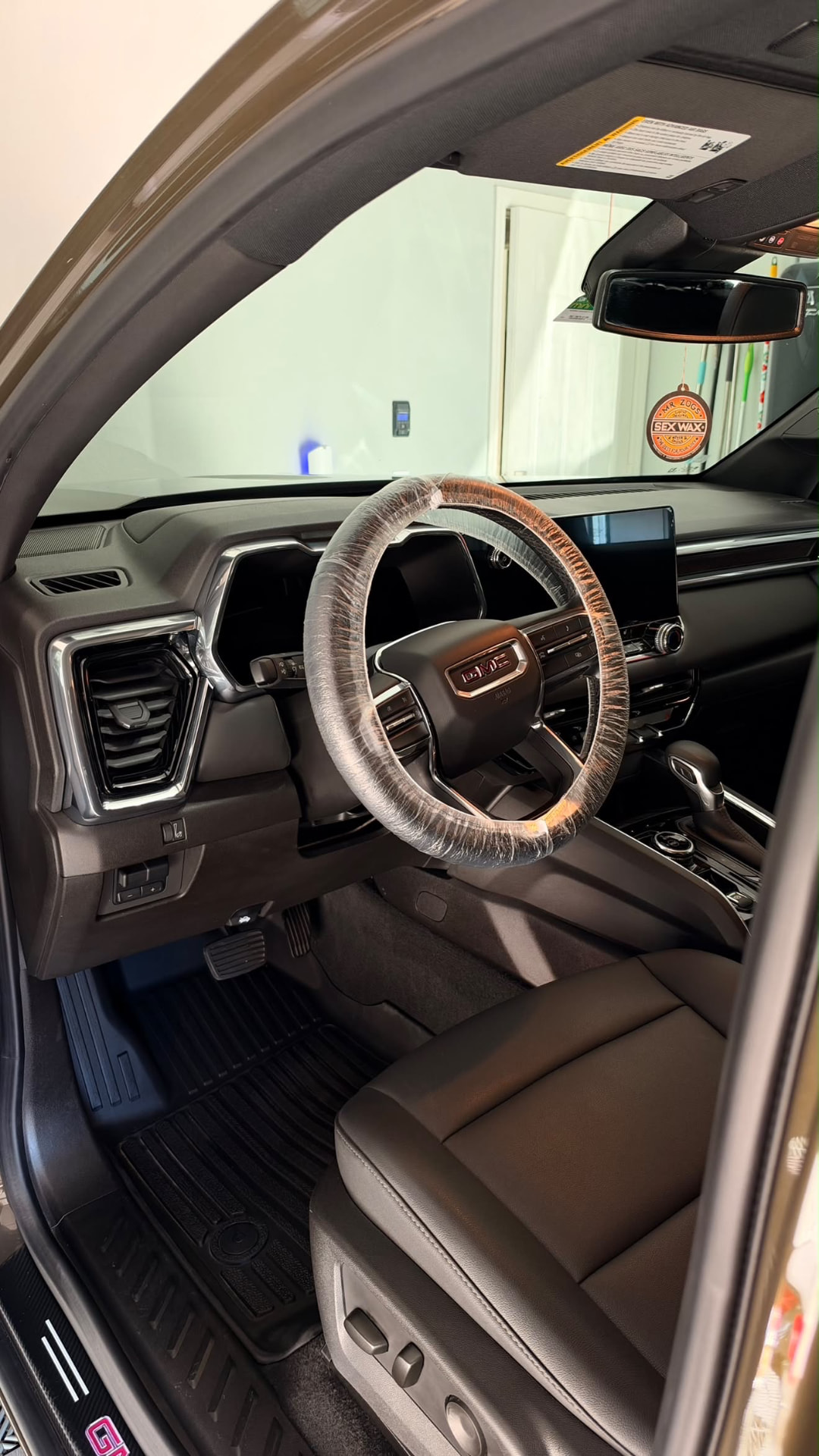 GMC truck interior with clean dash and protected steering wheel