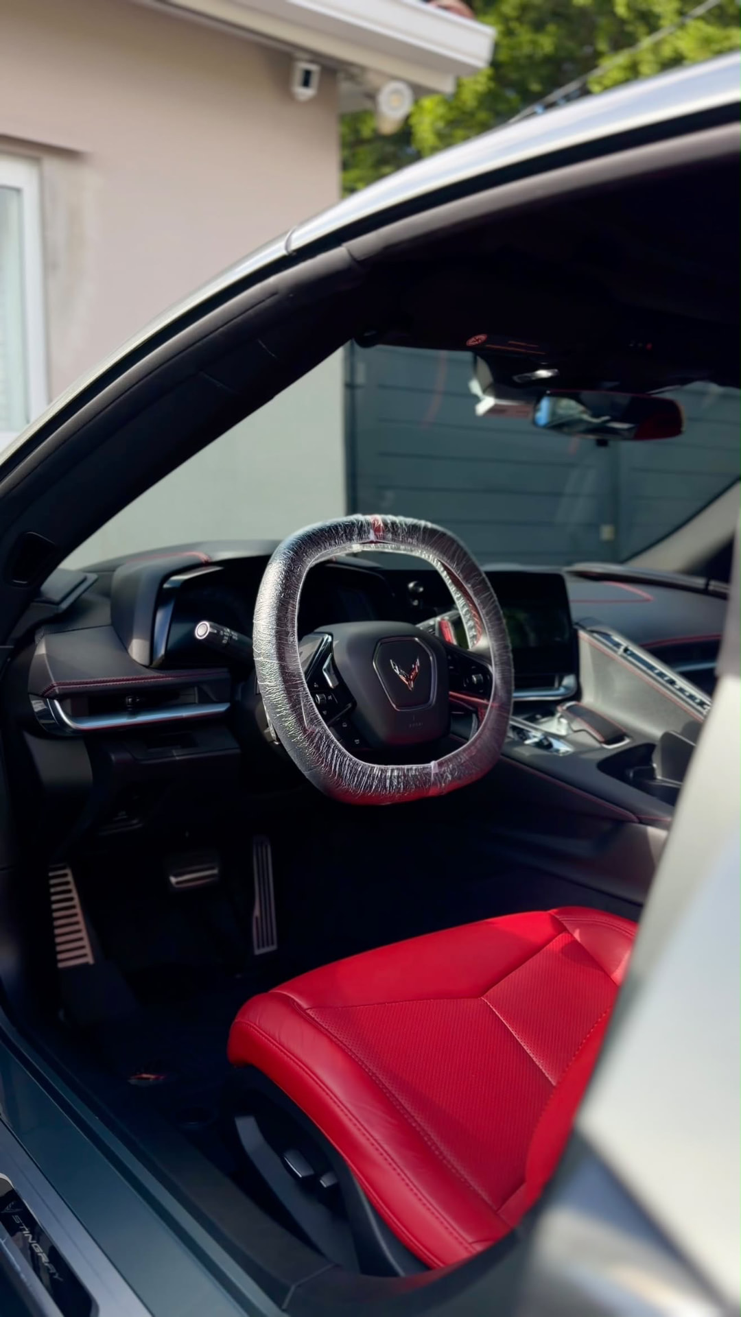 Corvette C8 interior with red leather seats and protected steering wheel
